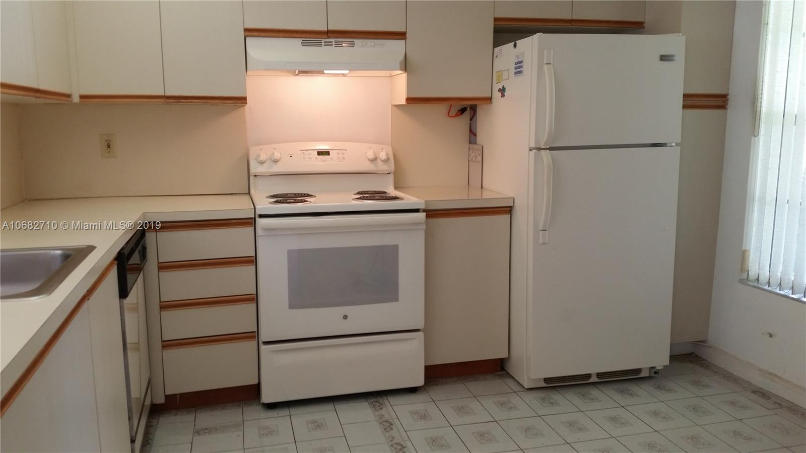 West Perrine Miami, FL 33157 - Photo 6 of 25 a white refrigerator freezer and a stove sitting inside of a kitchen