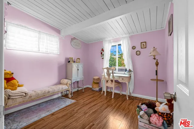 a kitchen with stainless steel appliances granite countertop a table chairs and a refrigerator