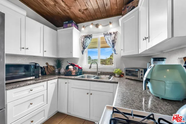 a kitchen with a table and chairs