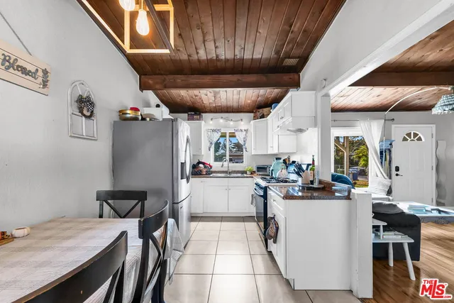 a kitchen with stainless steel appliances granite countertop a sink a stove and refrigerator