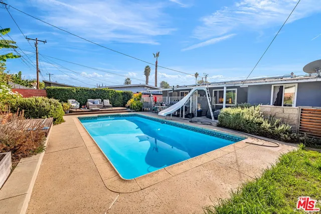 a view of a swimming pool with a patio