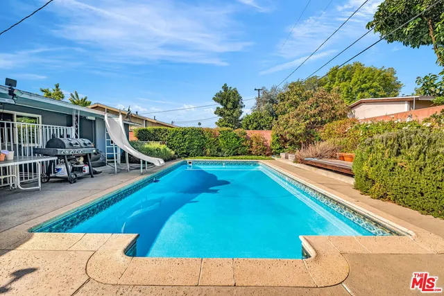 a view of a swimming pool with an outdoor seating
