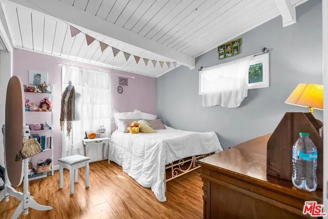 a bedroom with bed and a window