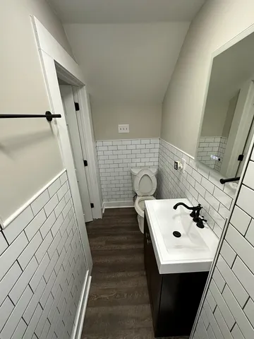 a bathroom with a sink and mirror with bathtub