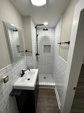 a bathroom with a sink a mirror and shower