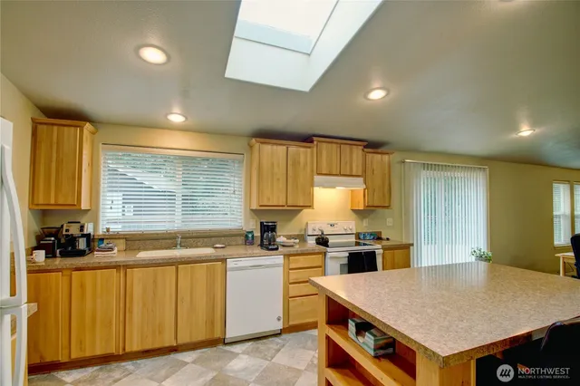 a kitchen with a table chairs sink and cabinets