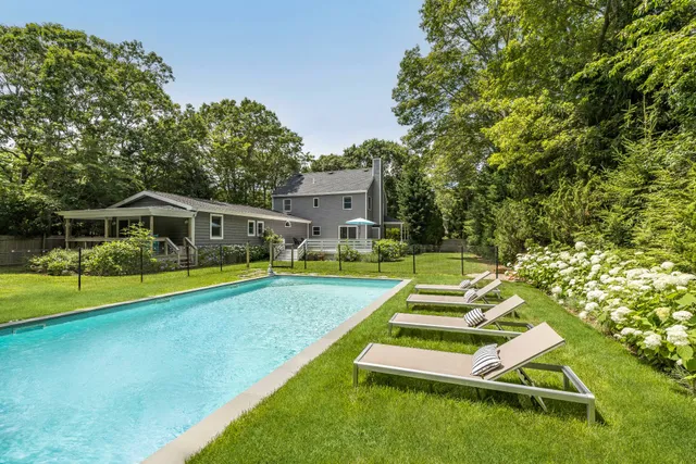 swimming pool with outdoor seating and yard