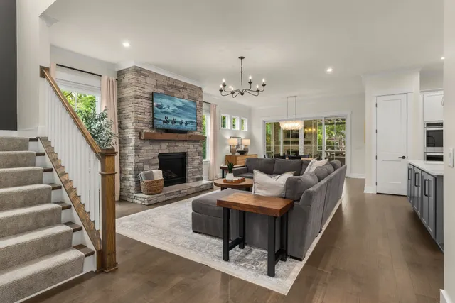 a living room with furniture a fireplace and a flat screen tv