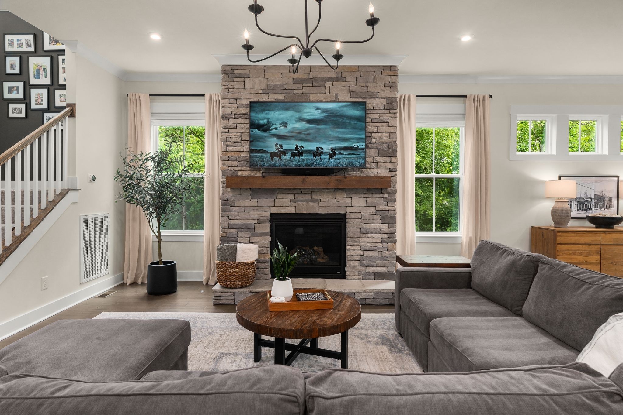 454 Cardel Lane Franklin, TN 37064 - Photo 13 of 53 a living room with furniture a fireplace and a chandelier