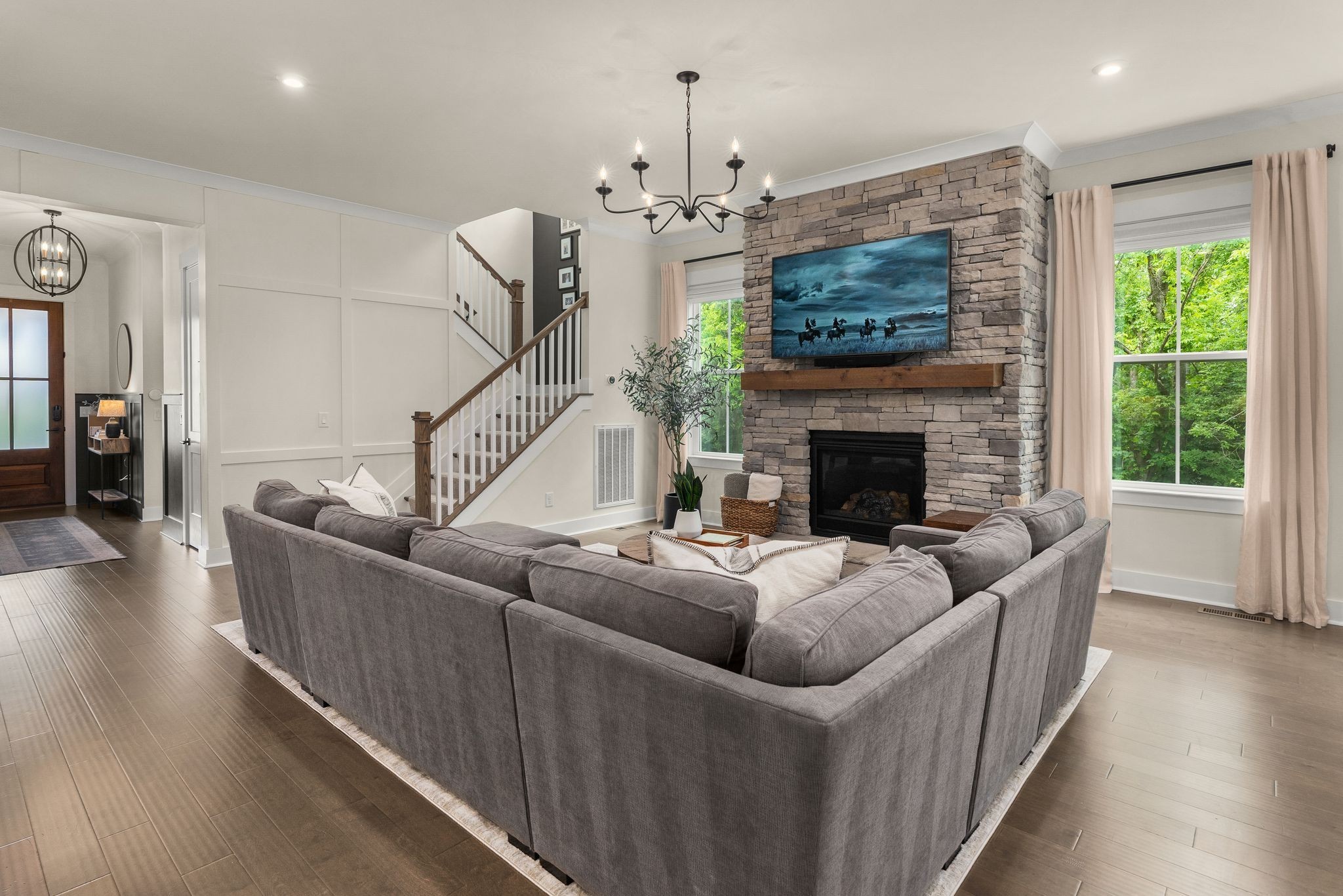 454 Cardel Lane Franklin, TN 37064 - Photo 14 of 53 a living room with furniture a fireplace and a chandelier