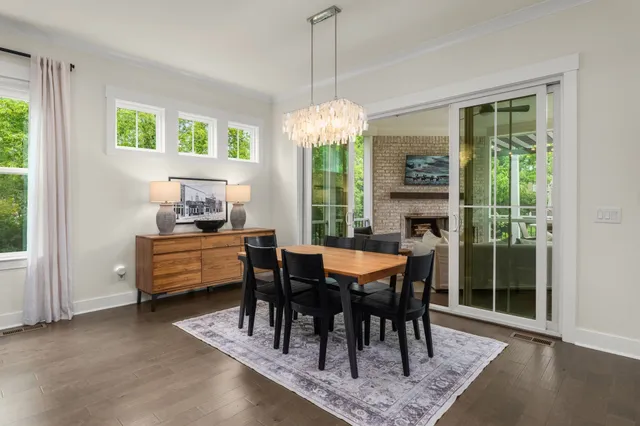 a dining room with furniture a chandelier and a rug