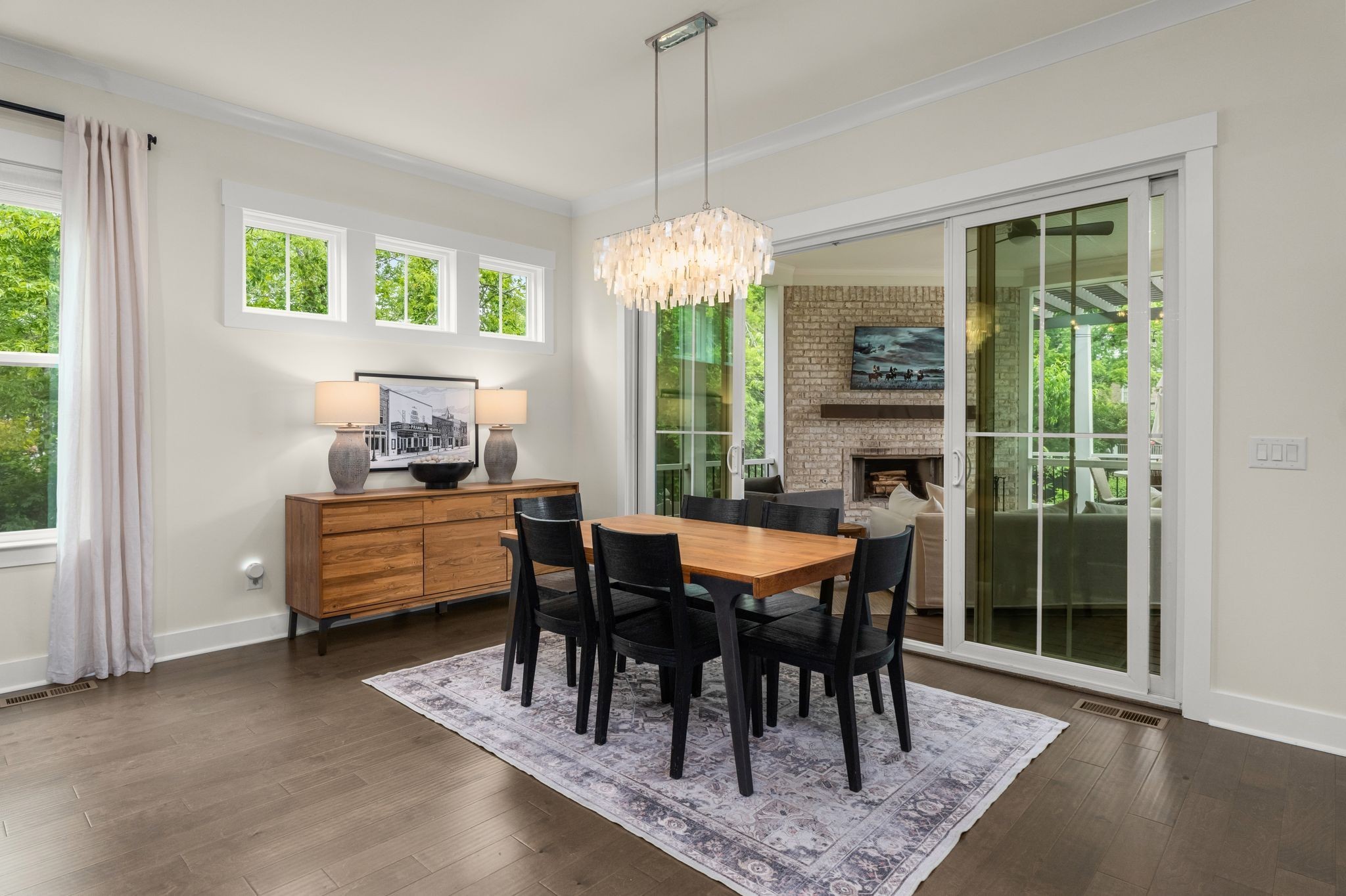 454 Cardel Lane Franklin, TN 37064 - Photo 17 of 53 a dining room with furniture a chandelier and a rug