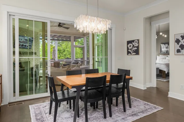 a dining room with furniture a rug and a chandelier