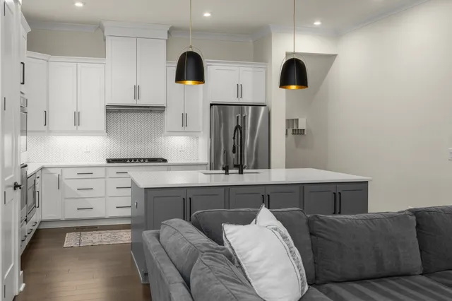 a living room with furniture and kitchen view