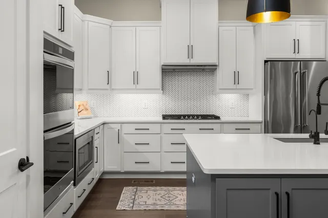 a kitchen with a sink a stove and refrigerator