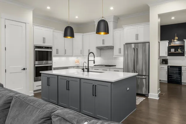 a kitchen with stainless steel appliances a sink and a refrigerator