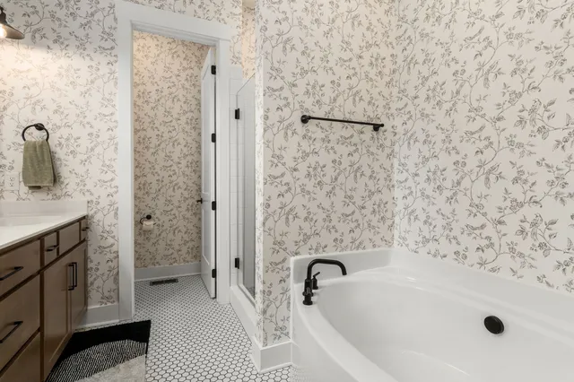 a bathroom with a sink a toilet and shower curtain