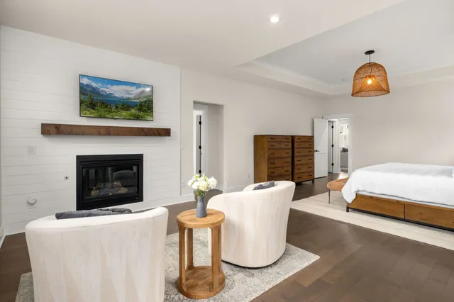 a bathroom with a tub a window and a glass door shower