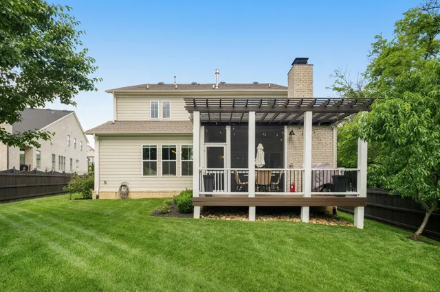an aerial view of a house with outdoor space pool seating area and yard