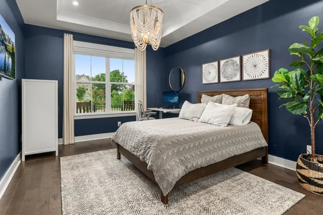 a large bed sitting in a bedroom next to a window