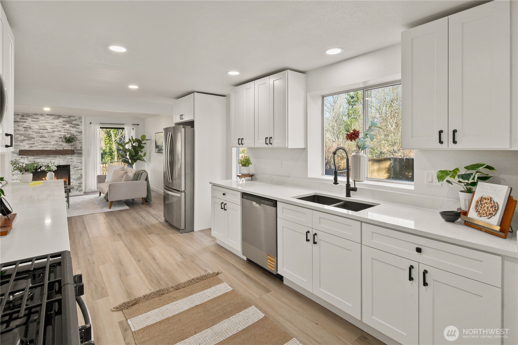 18307 130th Avenue Southeast Renton, WA 98058 - Photo 16 of 36 a kitchen with white cabinets and stainless steel appliances