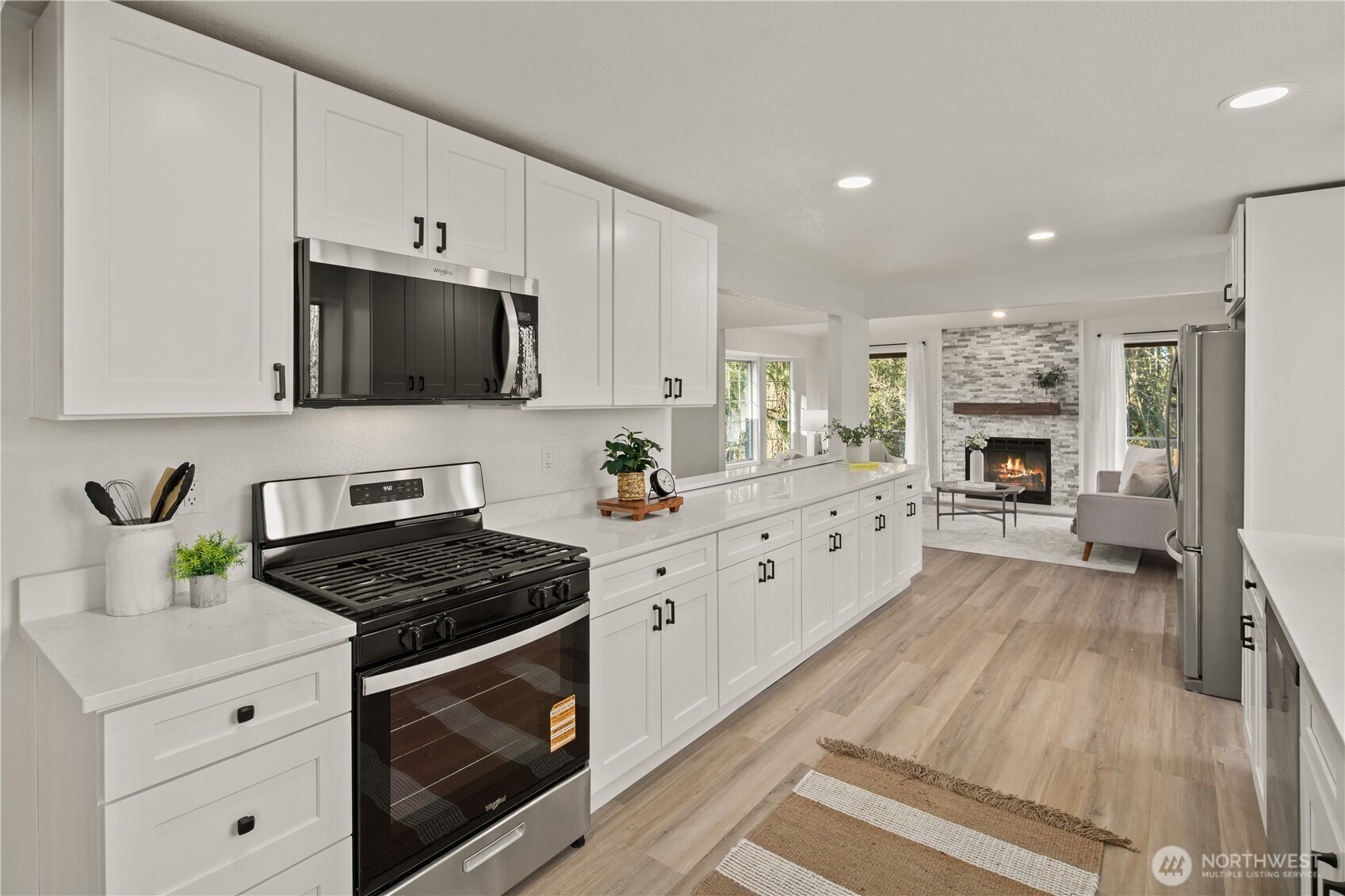 18307 130th Avenue Southeast Renton, WA 98058 - Photo 17 of 36 a kitchen with stainless steel appliances granite countertop a stove sink microwave and cabinets