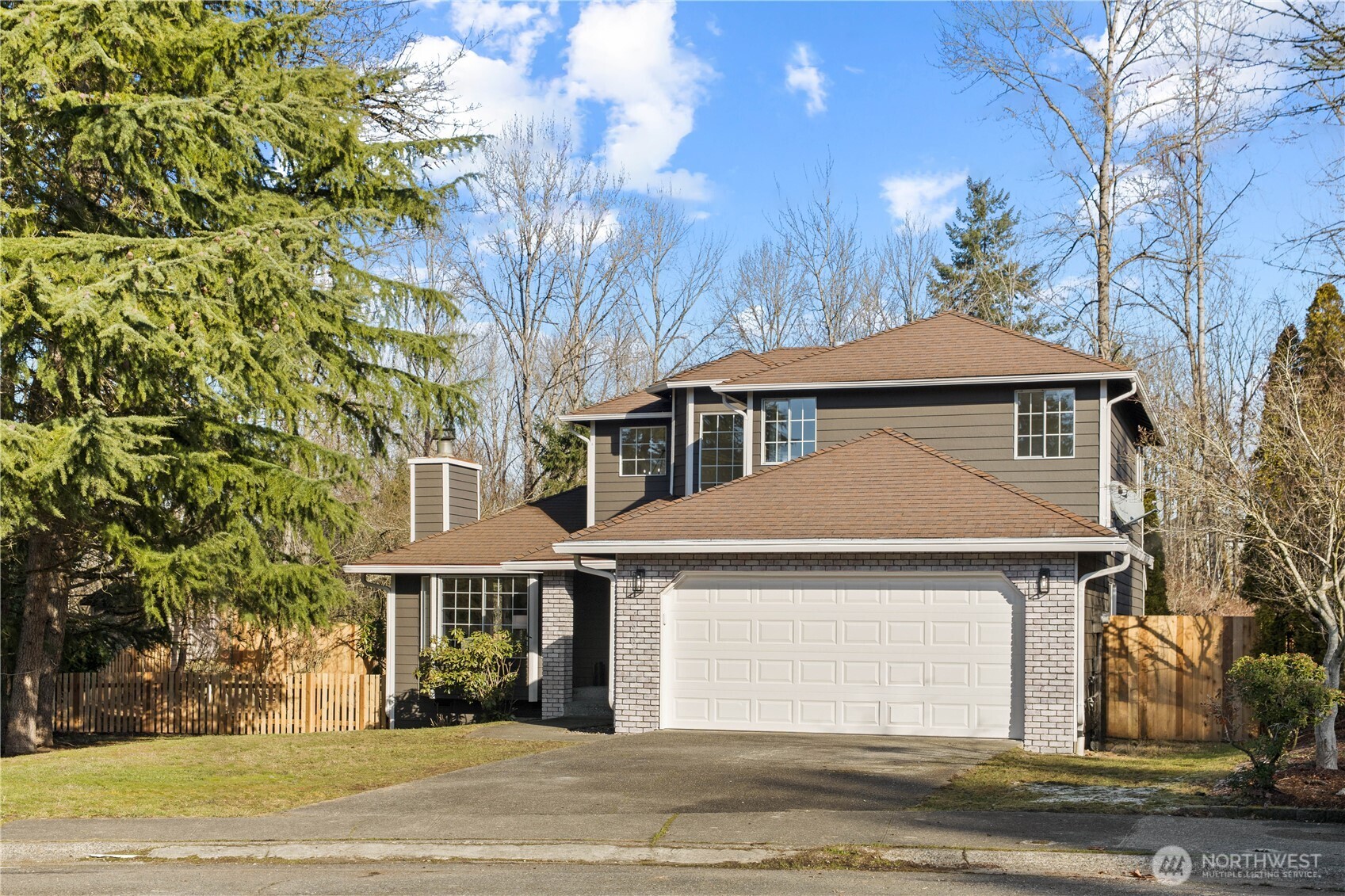 18307 130th Avenue Southeast Renton, WA 98058 - Photo 2 of 36 a front view of a house with a yard and garage