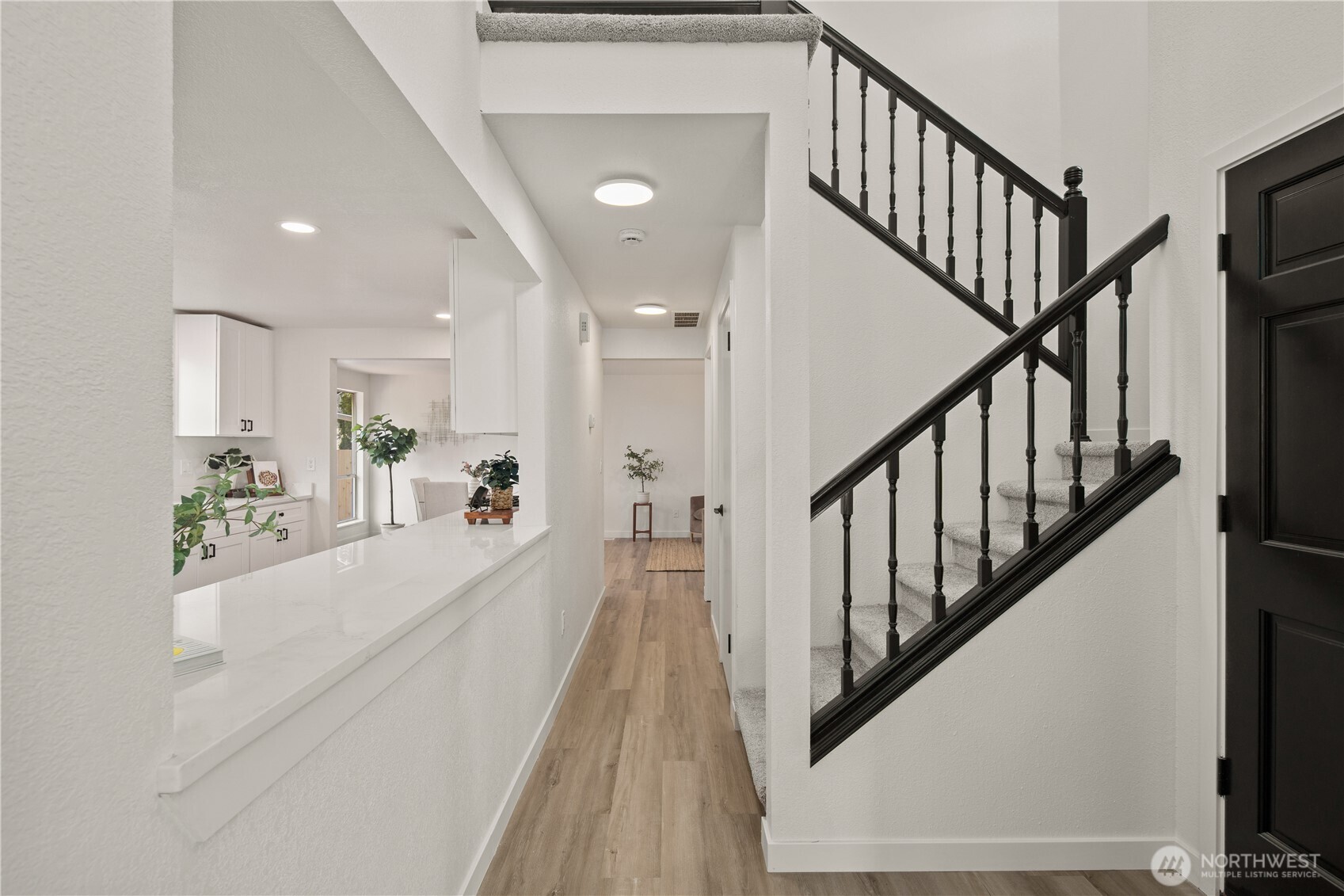 18307 130th Avenue Southeast Renton, WA 98058 - Photo 25 of 36 a view of a hallway with wooden floor and staircase