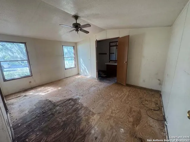 a view of empty room with a fireplace