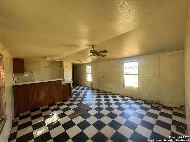a view of a livingroom with a black and white checkered floor
