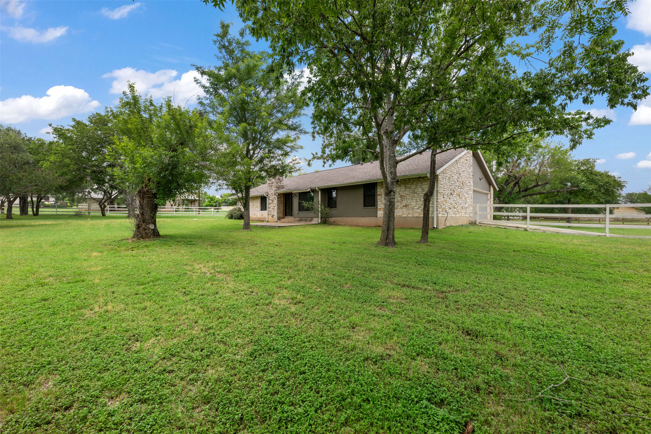 1600 Pin Oak Lane Round Rock, TX 78681 - Photo 34 of 40 Stone and siding exterior with mature trees