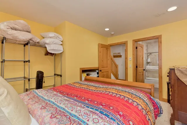 a view of a closet with wooden floor