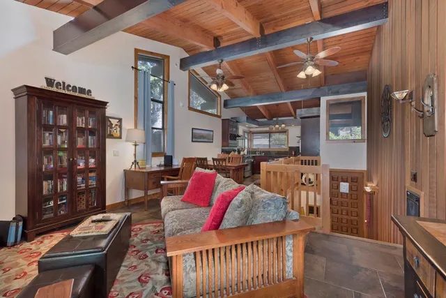 a living room with furniture fireplace and wooden floor