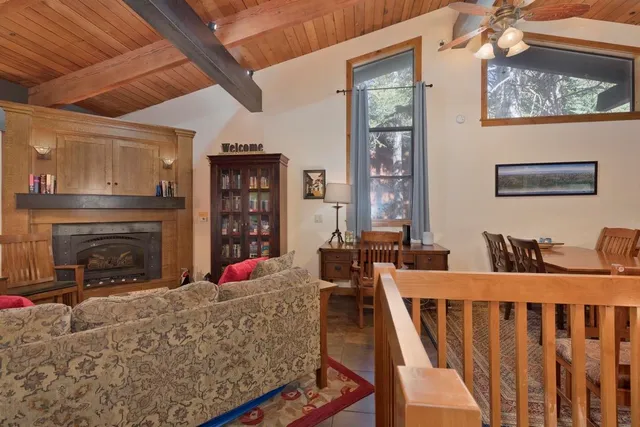 a living room with furniture a fireplace and a table