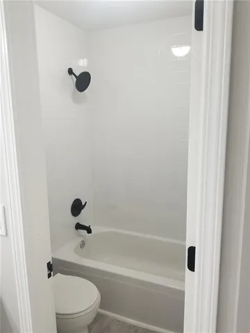 a bathroom with a shower a toilet and a shower
