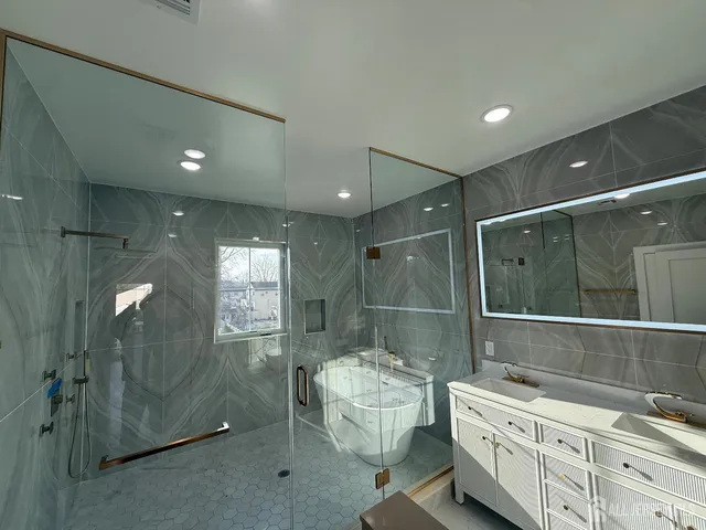 a bathroom with a double vanity sink toilet and shower