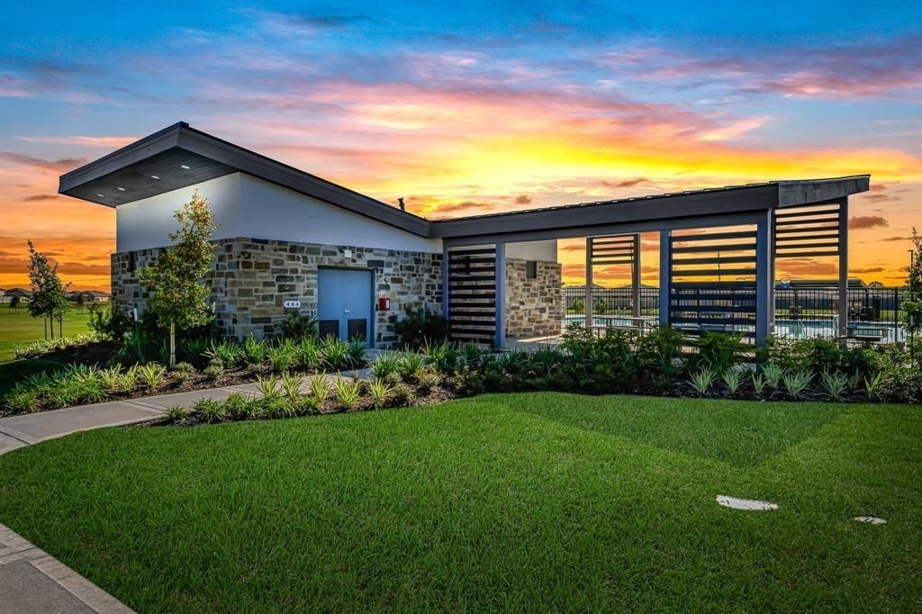 7826 Sleek Flock Lane Rosharon, TX 77583 - Photo 15 of 16 a front view of a house with a yard and potted plants