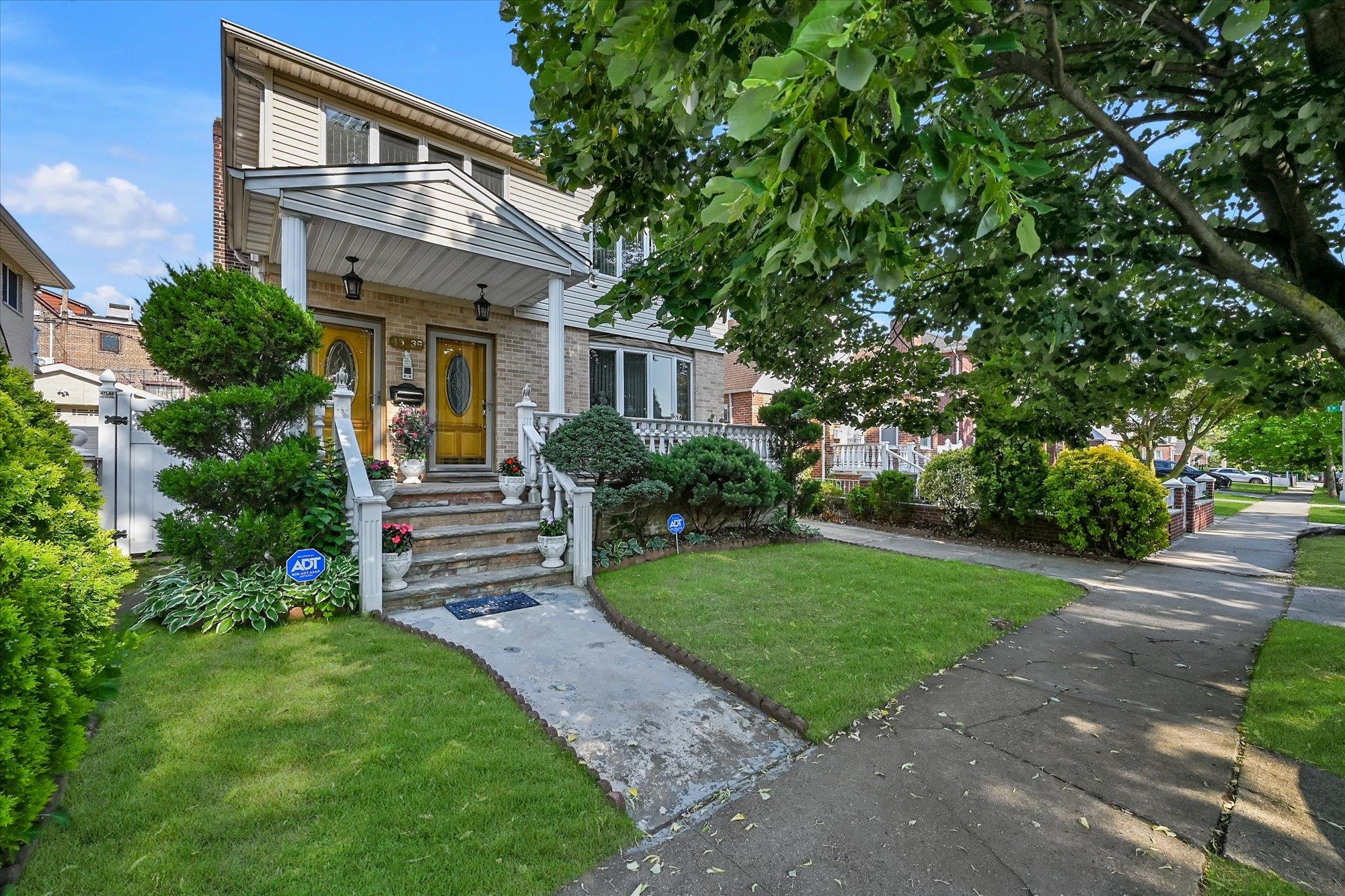 a front view of a house with a yard and outdoor seating
