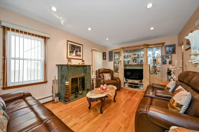 a living room with furniture a fireplace and a flat screen tv
