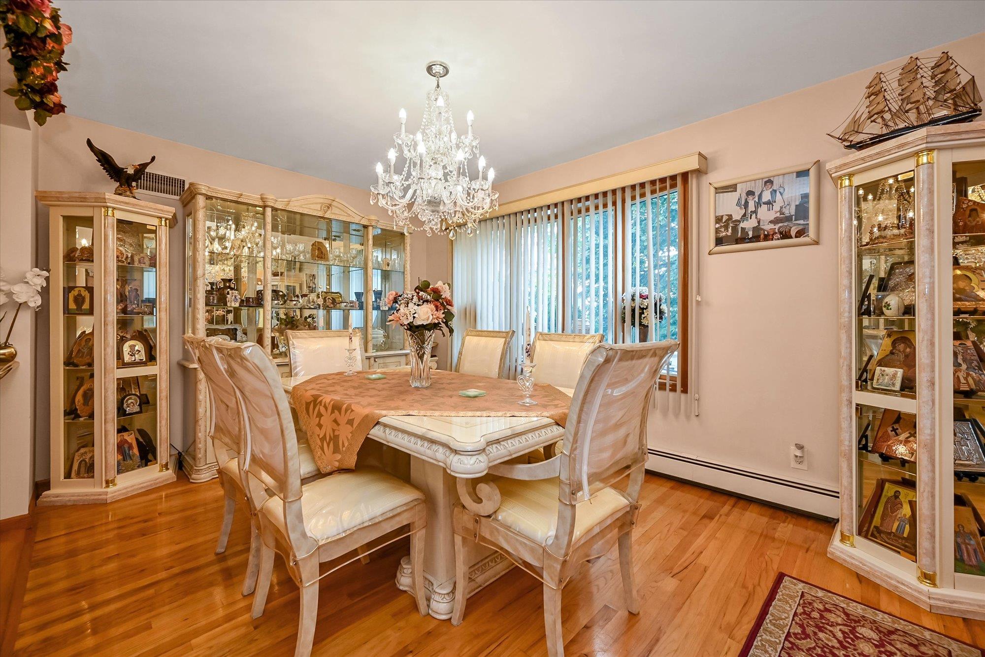 45-39 192nd Street Queens, NY 11358 - Photo 13 of 23 a view of a dining room with furniture a chandelier and wooden floor