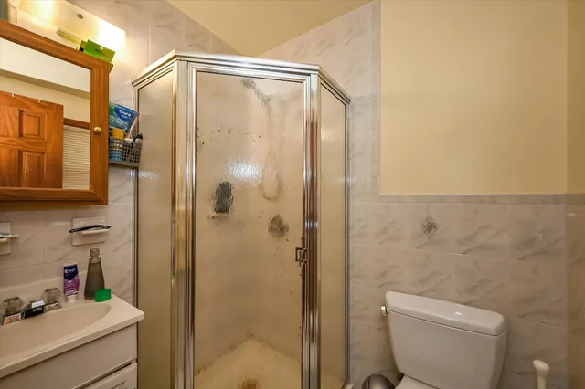 a bathroom with a shower a toilet and a sink