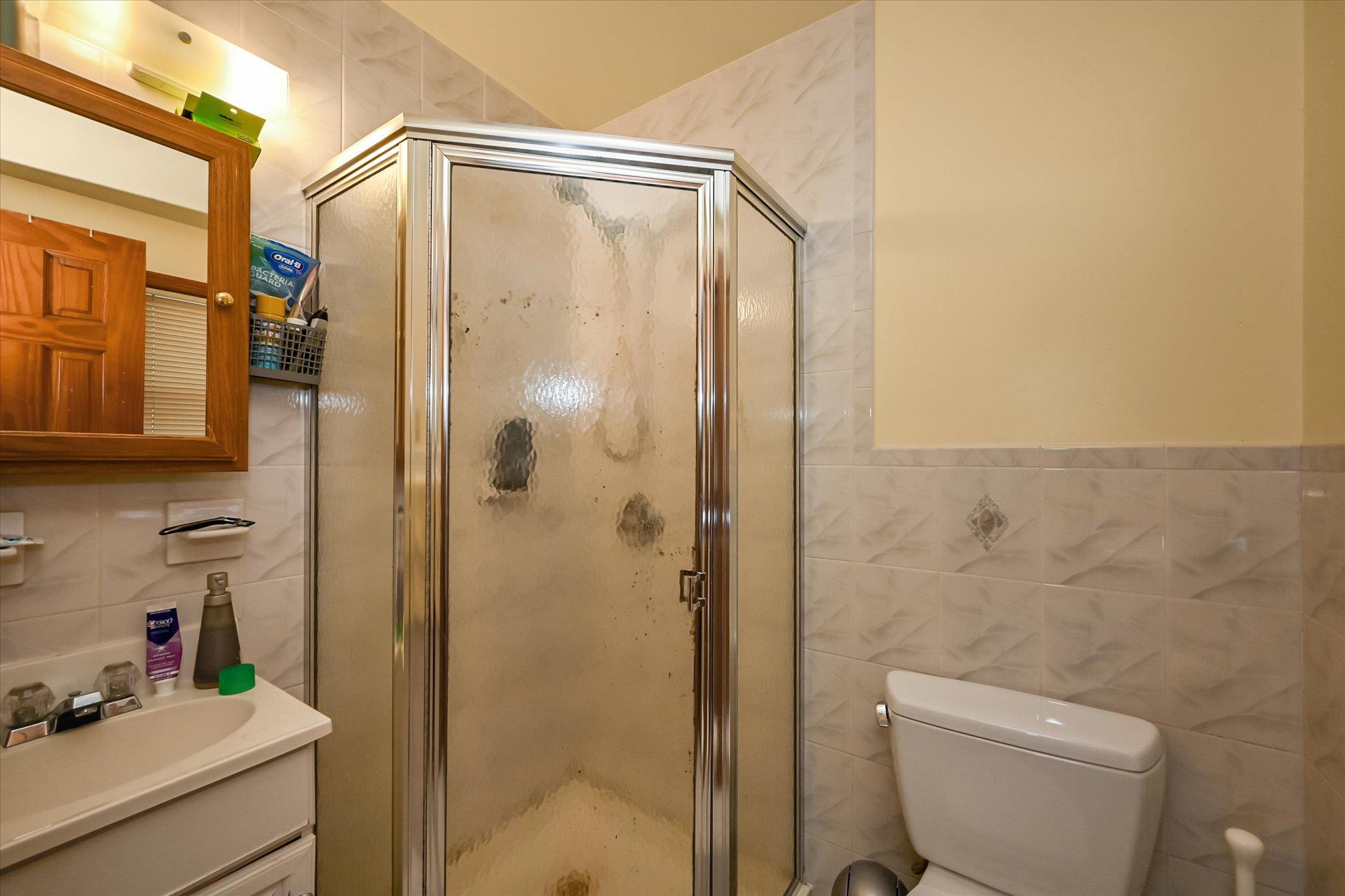 45-39 192nd Street Queens, NY 11358 - Photo 19 of 23 a bathroom with a shower a toilet and a sink
