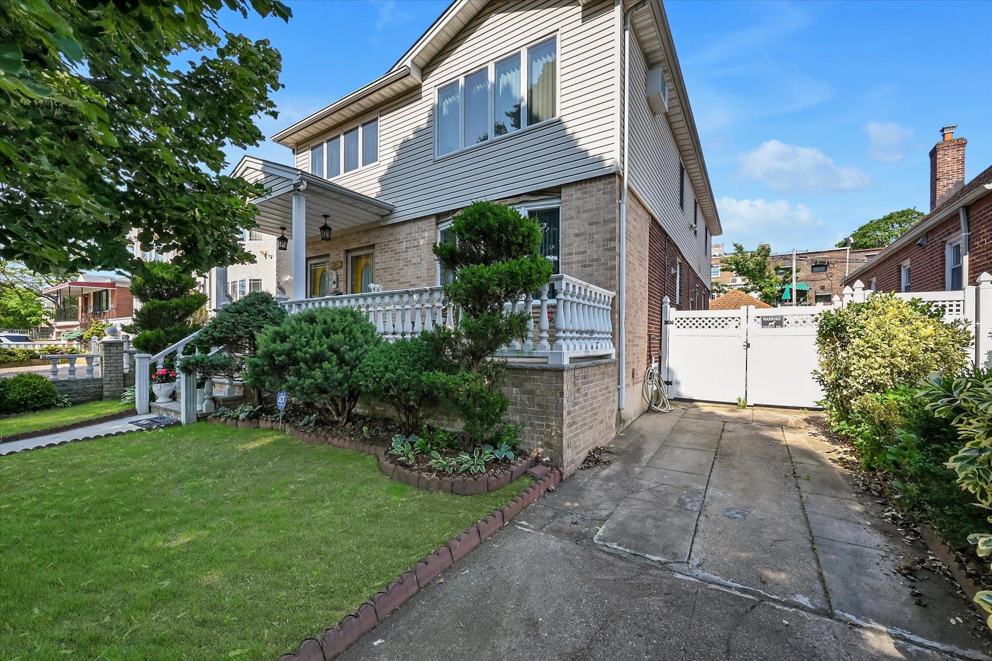 45-39 192nd Street Queens, NY 11358 - Photo 2 of 23 a front view of a house with a garden