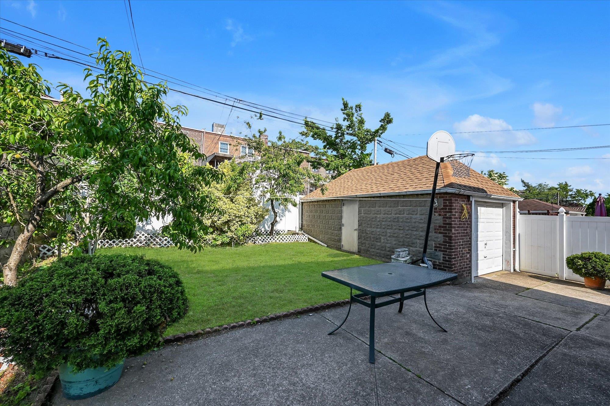 45-39 192nd Street Queens, NY 11358 - Photo 21 of 23 a front view of a house with a yard table and chairs
