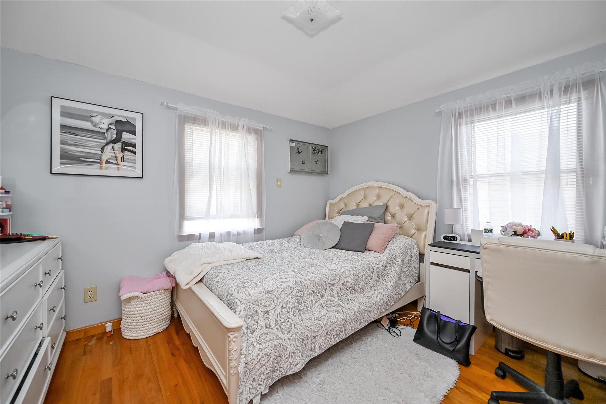 45-39 192nd Street Queens, NY 11358 - Photo 8 of 23 a bedroom with a bed and a chandelier