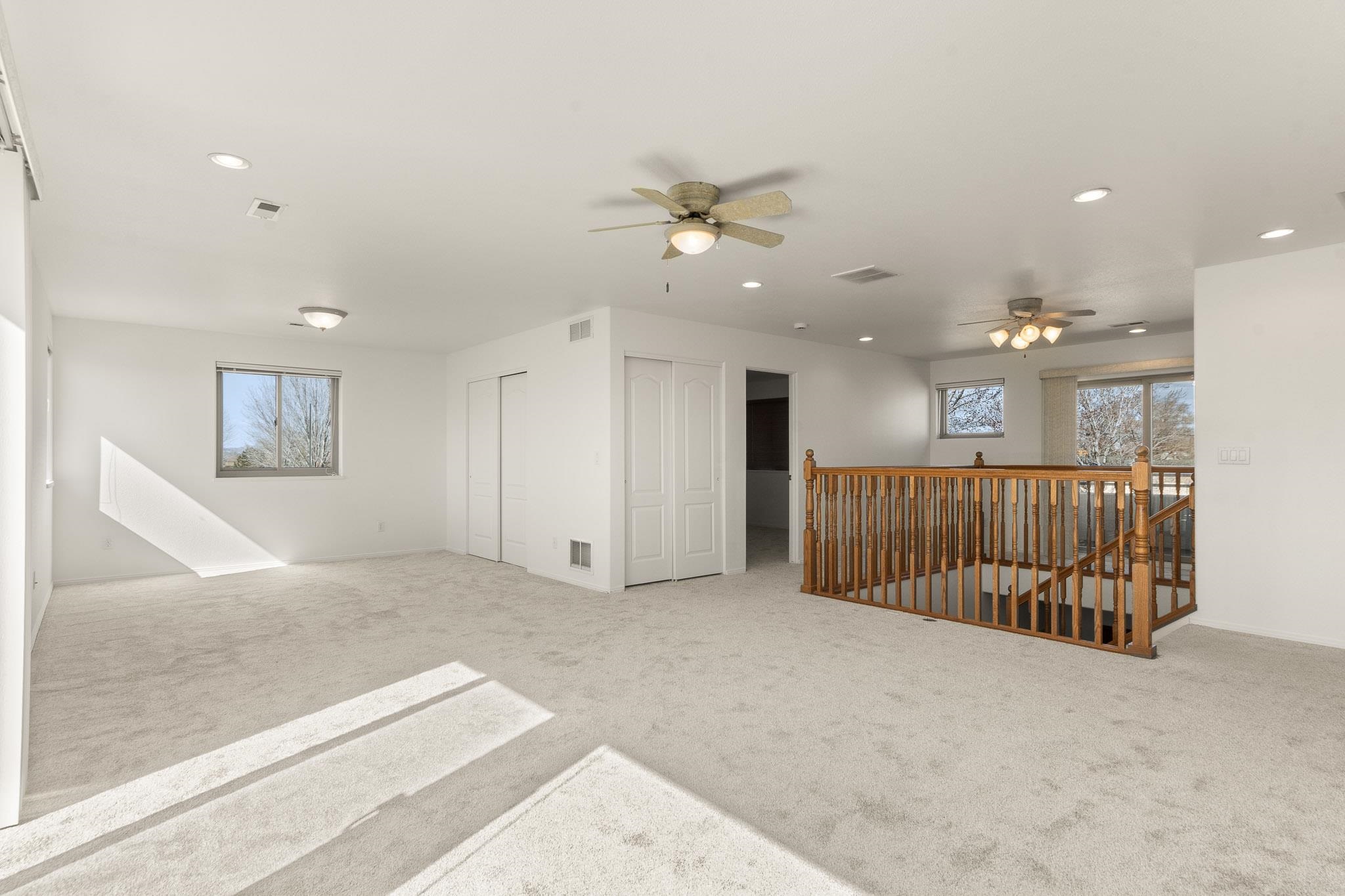 2107 I I- 1/2 Road Grand Junction, CO 81505 - Photo 24 of 42 a view of a livingroom with a ceiling fan and kitchen space