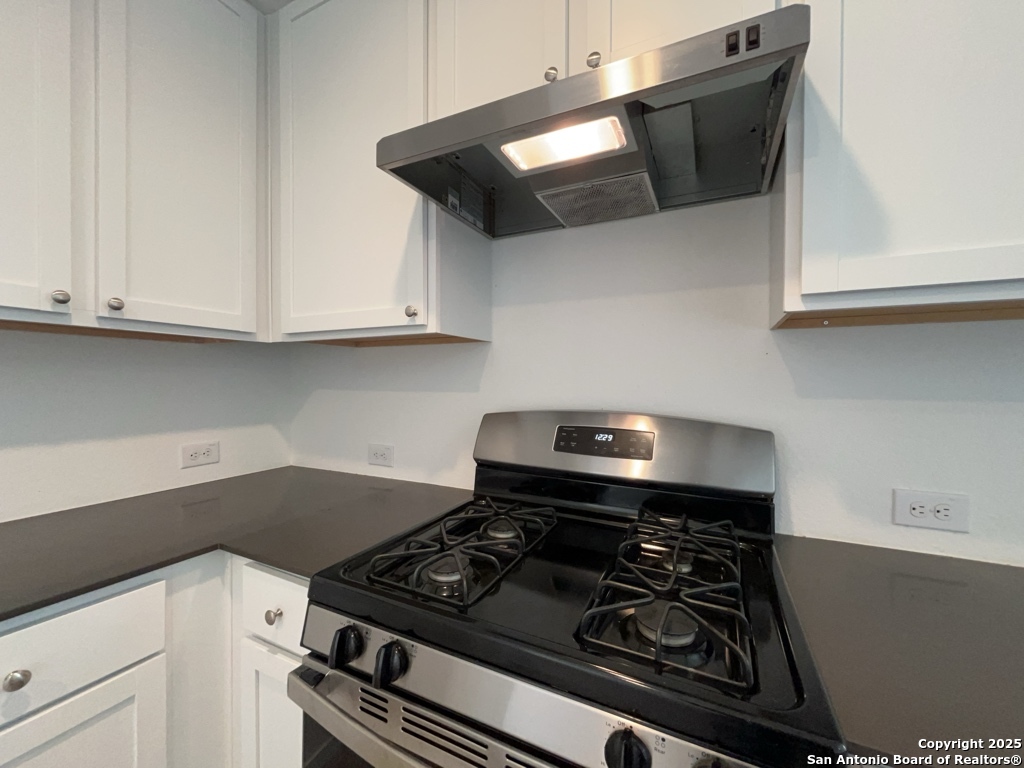 6954 Biotite Ridge Elmendorf, TX 78112 - Photo 11 of 39 a stove top oven sitting inside of a kitchen