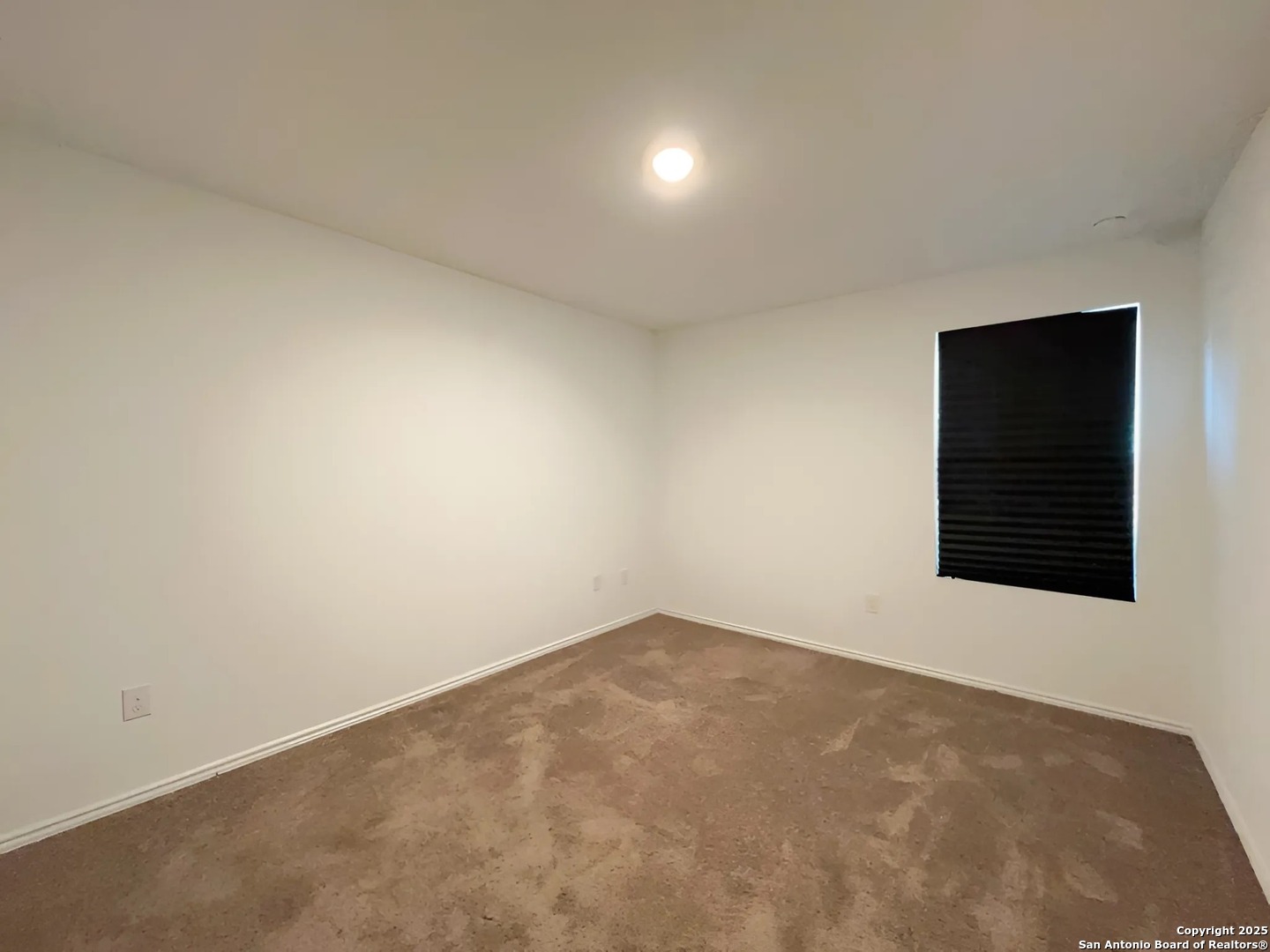 6954 Biotite Ridge Elmendorf, TX 78112 - Photo 14 of 39 an empty room with windows