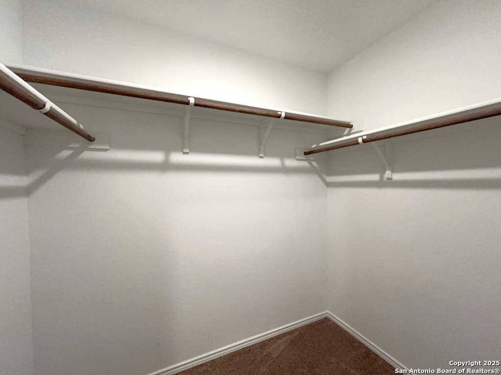 6954 Biotite Ridge Elmendorf, TX 78112 - Photo 17 of 39 a view of an empty walk in closet