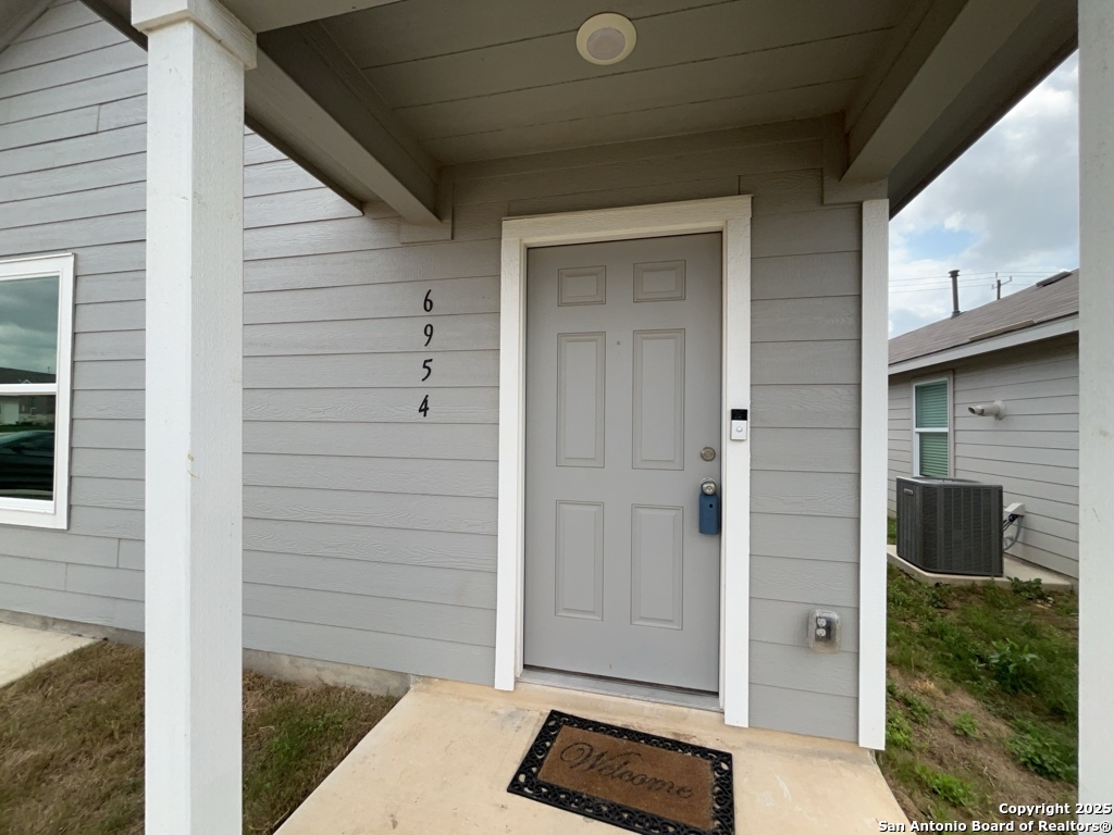 6954 Biotite Ridge Elmendorf, TX 78112 - Photo 29 of 39 a view of front door and mountain view